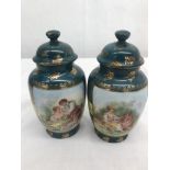 A pair of sevres style lidded urns