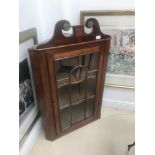 A Victorian mahogany corner cabinet with bone escutcheon