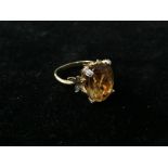 An 18ct gold stylized floral orange topaz & diamond dress ring