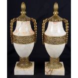 A Pair of Gilt Bronze and Onyx Lidded Vases: With geometric designs,