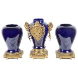 A 19th Century Clock Garniture: Clock set into blue ceramic urn with goat head finials,