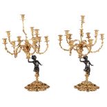 A Pair of Bronze and Gilt Candelabra: Ten sconces held up by a seated bronze Putti,