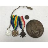 A WWI Death plaque named Lloyd Nutt and Mons Star named 7920 Pte L Nitt (family medals original