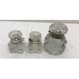 Three glass inkwells with silver-plated lids