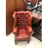 A child's leather wingback buttonback chair