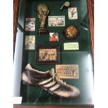 A small glass-cased montage of world cup memorabilia