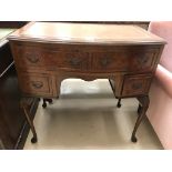 A Georgian-style leather-topped bow-fronted writing desk