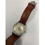 A 1950s gents manual Omega wristwatch with Omega buckle to leather strap