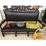 A 19th century French oak hunt sofa,, the back carved with swag designs,