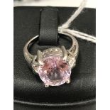 A 9ct white gold dress ring set with large oval cut pale pink amethyst