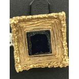 A 14ct gold abstract ring set with table cut square sapphire