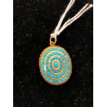 A gold turquoise pendant