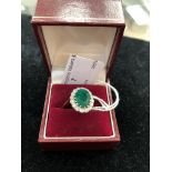 An 18ct emerald and diamond dress ring