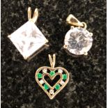 Three gold pendants: CZ,