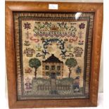 A 19th century framed sampler depicting a house and children dated 1891