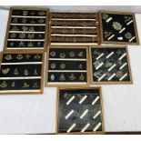 A large quantity of military cap badges