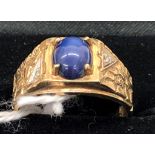 A gentleman's 10k gold blue star sapphire set ring