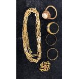 A quantity of gold rings together with a necklace