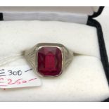 A gentleman's 10k red stone set ring