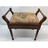 An upholstered mahogany piano stool