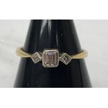 An 18ct diamond dress ring set with emerald cut stones