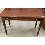 A mahogany side table with twin drawers and brass handles