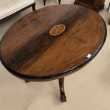 A mahogany inlaid breakfast table on four legs