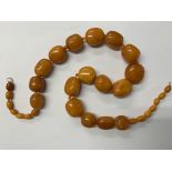 An amber bead necklace, total length 65cm,