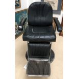 A vintage black and chrome barber's chair