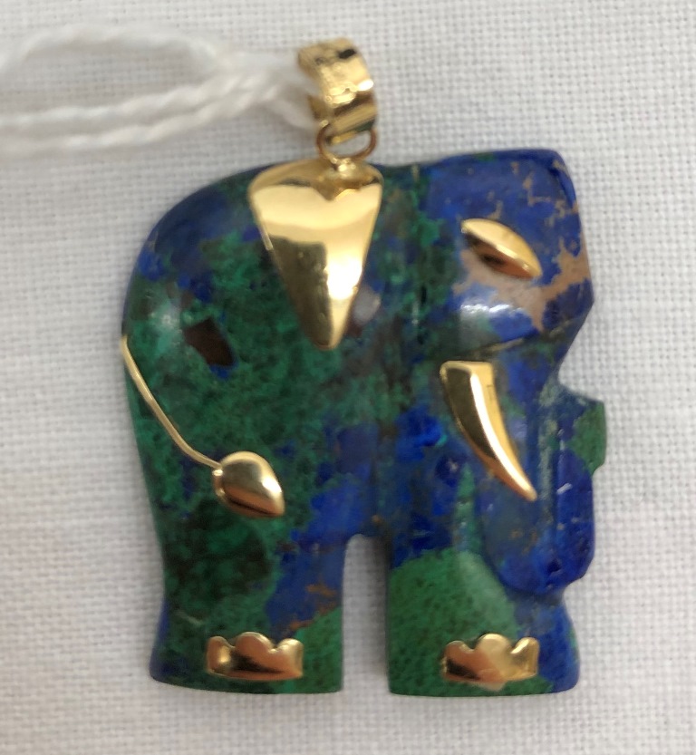 A gold set lapis lazuli elephant pendant