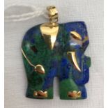 A gold set lapis lazuli elephant pendant