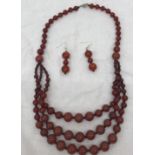 A carnelian bead necklace and earrings