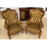 A pair of Victorian-style leather button-back chairs