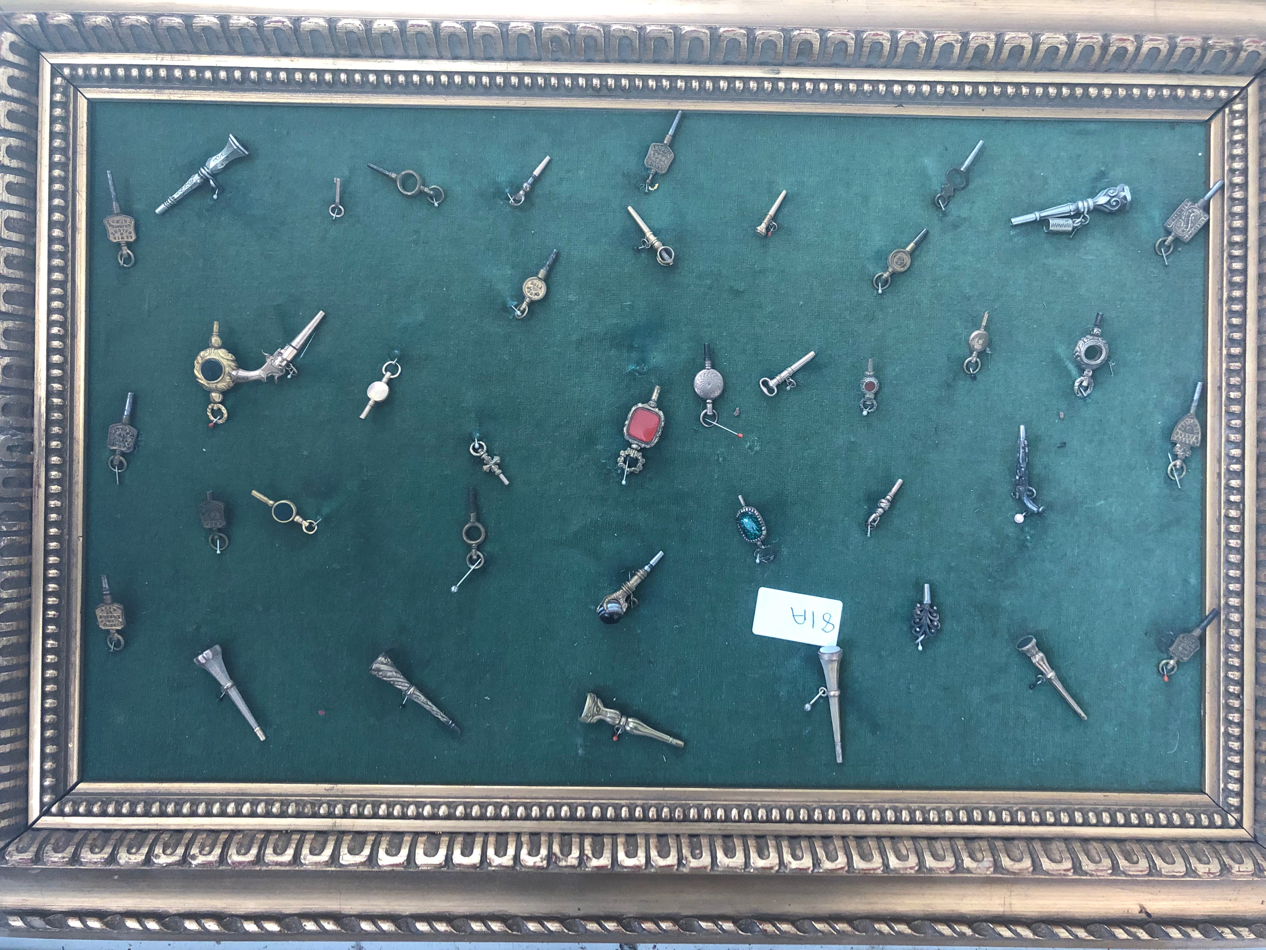 A quantity of framed watch keys to inc gold examples