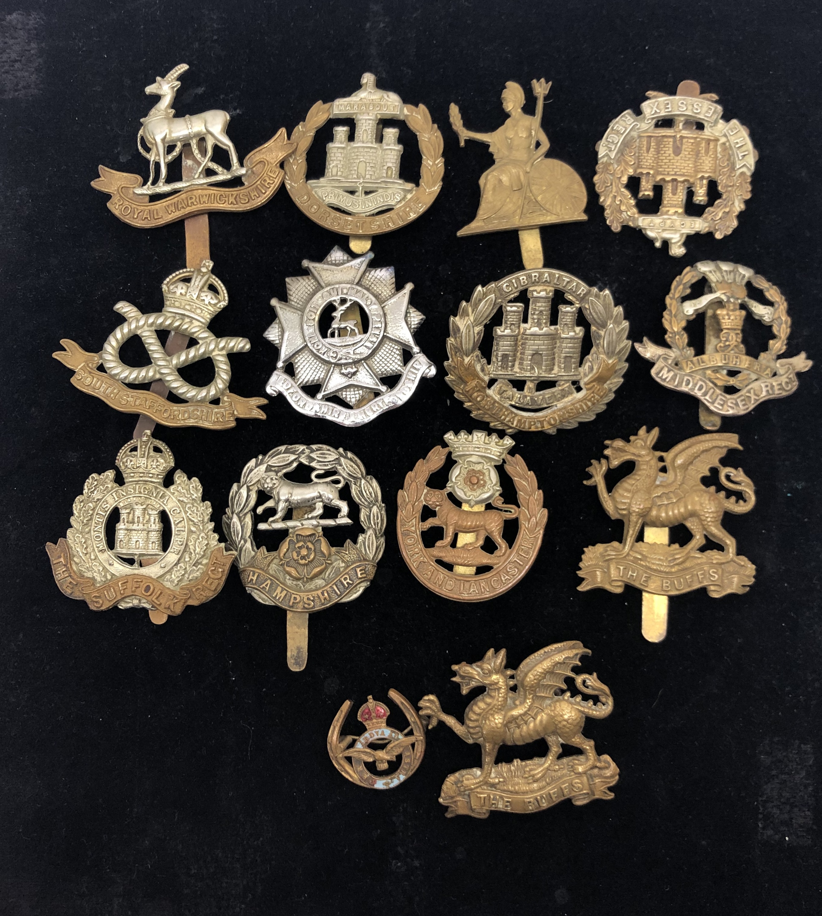 A quantity of WWII original cap badges