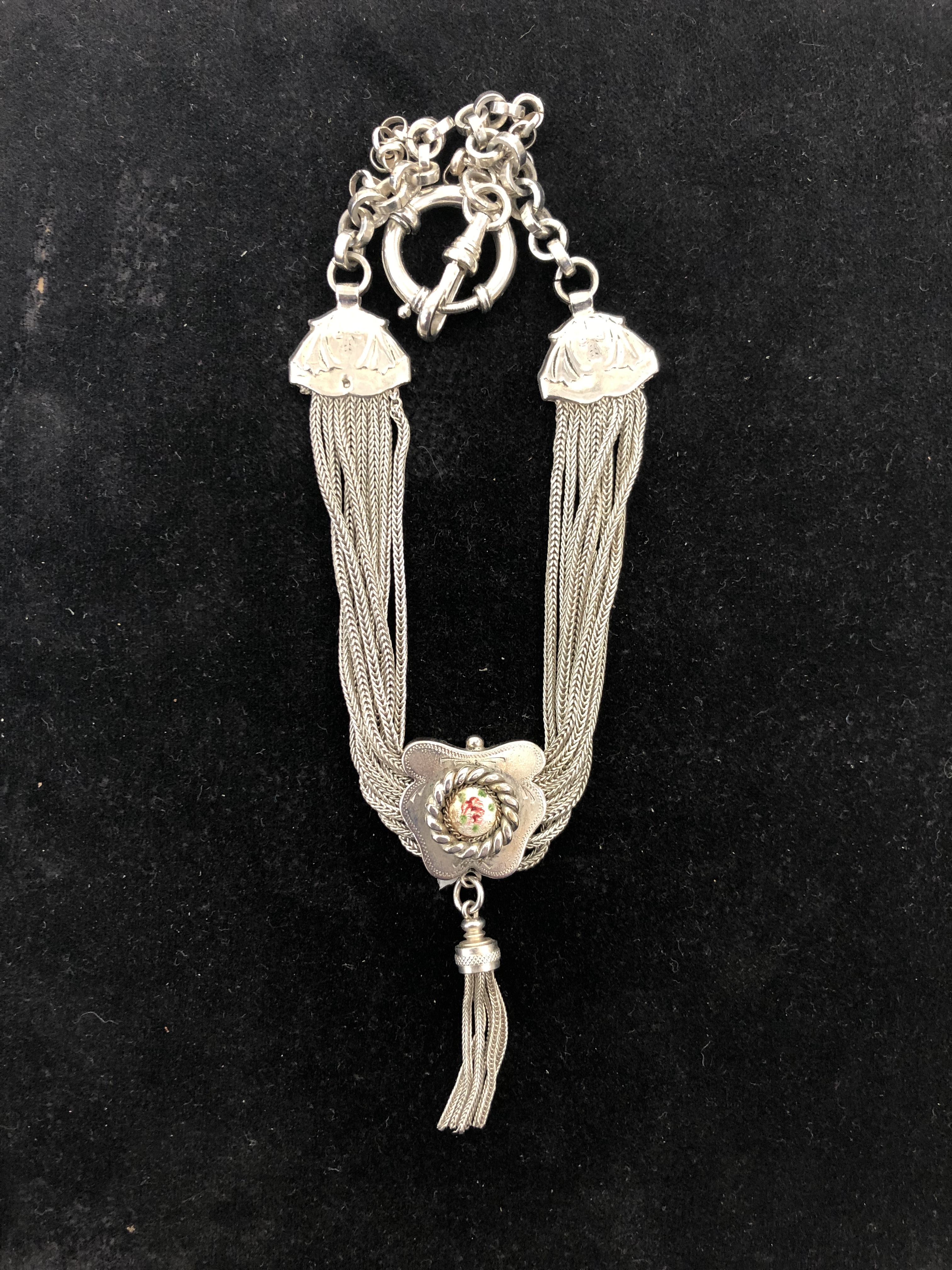 A white metal Albert chain with multi-strand enamelled button