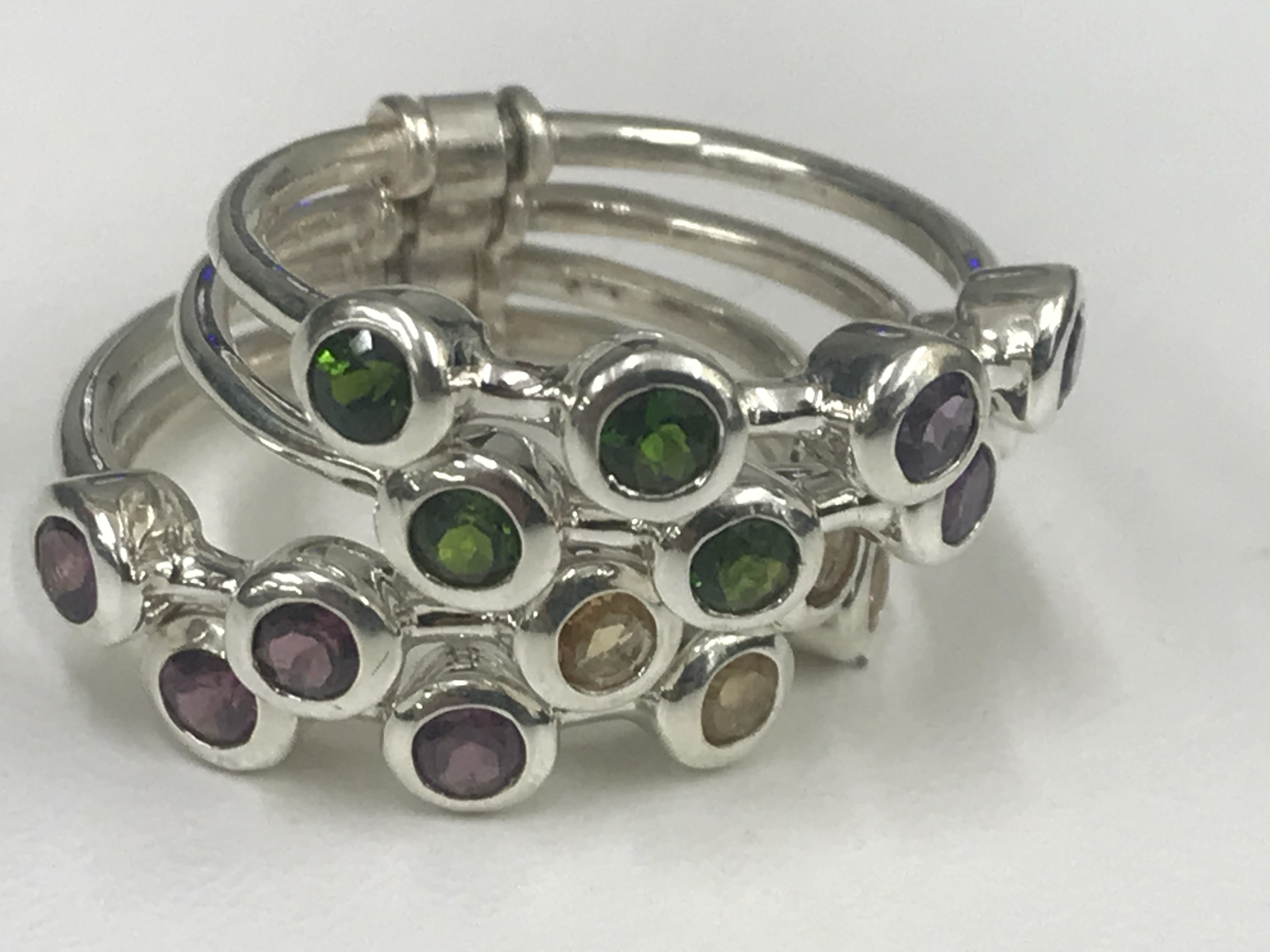 A silver four-ring ring with multi-stone set