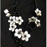 A black onyx and mother of pearl necklace