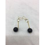 A pair of onyx and moonstone earrings