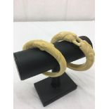 Two Art Nouveau period ivory carved bracelets: one depicting tigers,