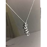 An 18ct diamond set swirl pendant on an 18ct chain