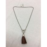 A silver necklace with leather pendant: Ti Sento,