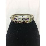 A silver multi-stone set bracelet: topaz, amethyst,