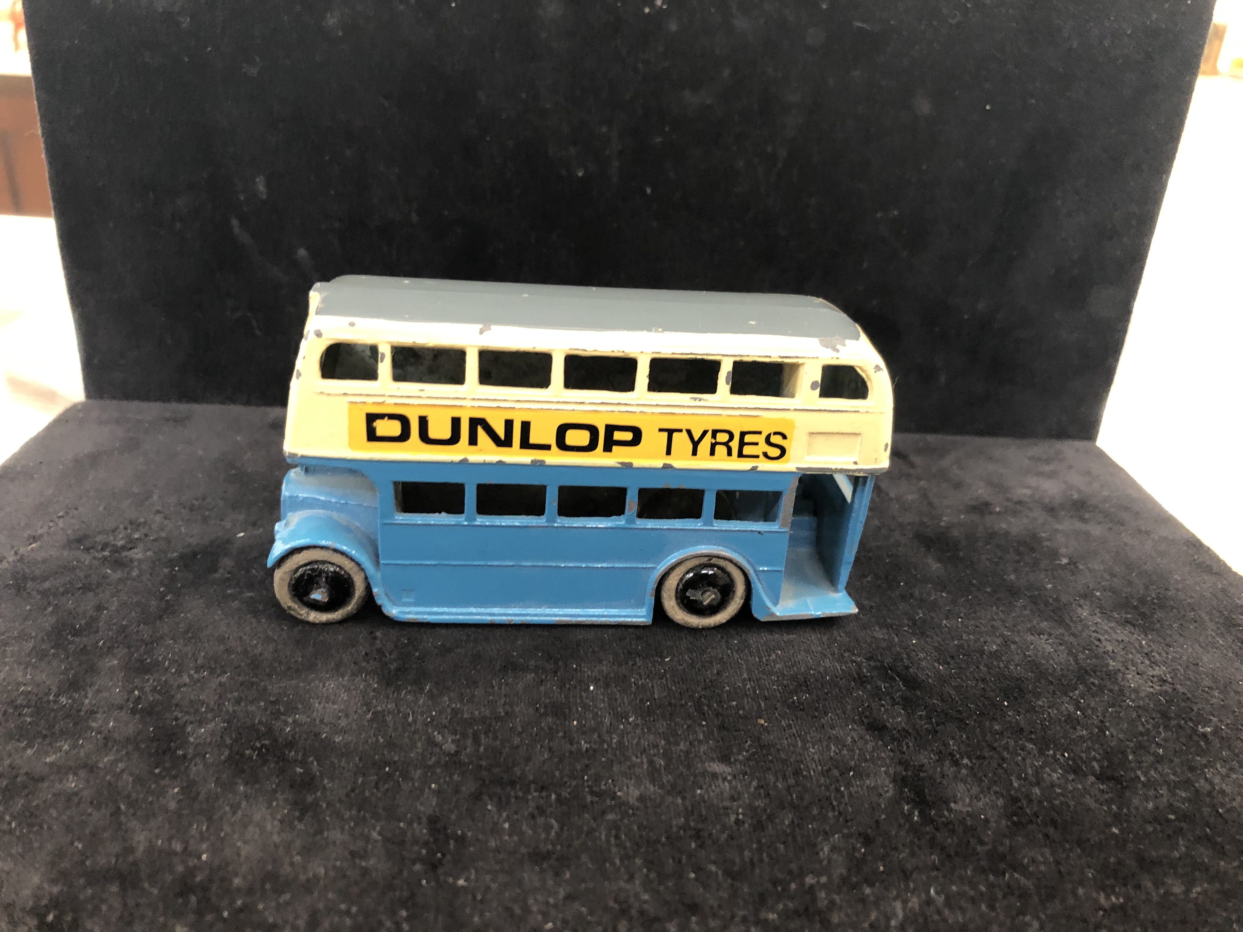 A pre-war Dinky bus with staircase and 'Dunlop tyres' in blue