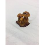 An amber figure of mushrooms