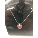 An 18ct ruby and diamond heart pendant on an 18ct chain