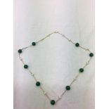 A 14k green onyx and pearl necklace