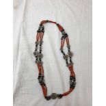 An antique coral and silver bead necklace,