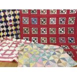 A quantity of patchwork quilts in geometric styles