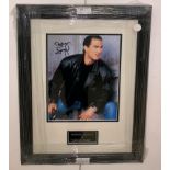 A framed & glazed signed photograph of Steven Seagal with COA